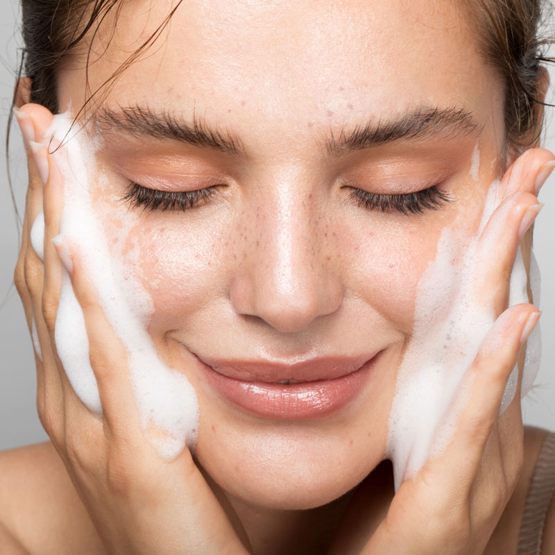 woman washing her face