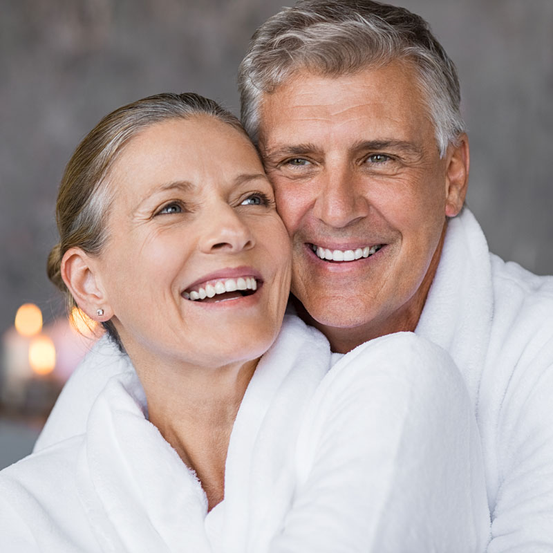 mature couple smiling in spa robes